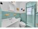 A well-maintained bathroom features vintage turquoise tiles, a functional shower, and a bright, clean atmosphere at 216 21St Ne Ave, St Petersburg, FL 33704