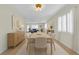 Inviting dining room with table set for six, showcasing modern lighting and neutral color palette at 216 21St Ne Ave, St Petersburg, FL 33704