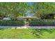Inviting home featuring a manicured lawn and garden, partially concealed behind a lush privacy hedge at 216 21St Ne Ave, St Petersburg, FL 33704