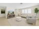 Bright living room with large window and stylish neutral decor, featuring a comfortable seating arrangement at 216 21St Ne Ave, St Petersburg, FL 33704