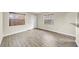 Bright living room featuring wood-look tile flooring, neutral walls, and natural light from two windows at 216 21St Ne Ave, St Petersburg, FL 33704