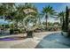 Modern outdoor dining area with stylish umbrellas, tables, and artistic sculptures surrounded by palm trees at 216 21St Ne Ave, St Petersburg, FL 33704