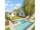 Modern backyard oasis with a sparkling pool, lounge chairs, and lush landscaping for ultimate relaxation at 216 21St Ne Ave, St Petersburg, FL 33704