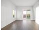 Bright bedroom with hardwood floors, balcony access, and natural light from large windows at 2910 W Barcelona St # Ph-2303, Tampa, FL 33629