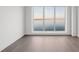 Bright bedroom featuring hardwood floors and a large window with scenic water views at 2910 W Barcelona St # Ph-2303, Tampa, FL 33629