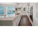 Modern kitchen with white cabinetry, stainless steel appliances, a large island, and stunning water views at 2910 W Barcelona St # Ph-2303, Tampa, FL 33629