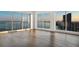 Elegant living room featuring hardwood floors, expansive windows, and stunning views of the water and city skyline at 2910 W Barcelona St # Ph-2303, Tampa, FL 33629