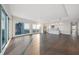 Bright, open living area with a modern kitchen, hardwood floors, and walls of windows showcasing stunning city and water views at 2910 W Barcelona St # Ph-2303, Tampa, FL 33629