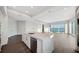 Bright open-concept living space with gourmet kitchen, island, and floor-to-ceiling windows displaying scenic waterfront views at 2910 W Barcelona St # Ph-2303, Tampa, FL 33629