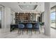 Modern wet bar with marble countertop, stylish seating, and well-stocked shelving at 2910 W Barcelona St # Ph-2303, Tampa, FL 33629