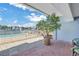 Brick patio overlooking the waterfront features a pool and lush landscaping at 340 Pinellas Bayway S # 306, Tierra Verde, FL 33715