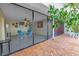 Screened-in patio leads to an outdoor brick patio with furniture and water views at 340 Pinellas Bayway S # 306, Tierra Verde, FL 33715