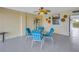 Screened-in patio area with table, chairs, and ceiling fan for outdoor dining and entertaining at 340 Pinellas Bayway S # 306, Tierra Verde, FL 33715