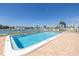 Rectangular pool is surrounded by brick pavers and offers waterfront views and lounge chairs at 340 Pinellas Bayway S # 306, Tierra Verde, FL 33715