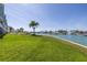 Scenic waterfront view with lush lawn and marina, offering serene outdoor living at 340 Pinellas Bayway S # 306, Tierra Verde, FL 33715