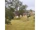 A backyard view shows the outdoor space and community in the distance at 4920 Locust Ne St # 203, St Petersburg, FL 33703