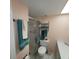 Comfortable bathroom featuring a shower, modern vanity, and storage for towels and toiletries at 4920 Locust Ne St # 203, St Petersburg, FL 33703