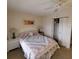 Cozy bedroom with a bed, two end tables and lamps and a closet with bifold doors at 4920 Locust Ne St # 203, St Petersburg, FL 33703