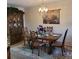 Traditional dining room featuring wooden table, seating for six, and decorative china cabinet at 4920 Locust Ne St # 203, St Petersburg, FL 33703