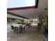 Outdoor patio with tables and chairs, perfect for relaxing by the pool at 4920 Locust Ne St # 203, St Petersburg, FL 33703