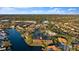 Aerial view of townhomes with a red pin, surrounded by lush landscapes and water views at 6320 Grand Bahama Cir # 6320, Tampa, FL 33615