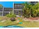 Waterfront backyard with lush greenery, a fire pit, and water access at 6320 Grand Bahama Cir # 6320, Tampa, FL 33615