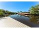 Wide canal view from private dock featuring lovely homes, pool, dock, and tropical foliage at 6320 Grand Bahama Cir # 6320, Tampa, FL 33615