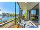 Enjoy the view from this cozy screened-in balcony with a grill and serene waterfront scenery at 6320 Grand Bahama Cir # 6320, Tampa, FL 33615