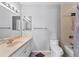 Neutral bathroom with a single sink vanity, bath, shower, and toilet with tiled floor at 6320 Grand Bahama Cir # 6320, Tampa, FL 33615