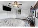 Bedroom with hardwood floors, ceiling fan, desk, closet, and television at 6320 Grand Bahama Cir # 6320, Tampa, FL 33615