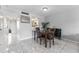 Dining room area with tile floor, dark wood table set, and an open view to the kitchen at 6320 Grand Bahama Cir # 6320, Tampa, FL 33615
