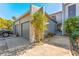 Charming home with a two-car garage, walkway and beautiful plants on a sunny day at 6320 Grand Bahama Cir # 6320, Tampa, FL 33615