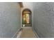 Charming entryway featuring an arched doorway, textured walls, and a potted plant at 6320 Grand Bahama Cir # 6320, Tampa, FL 33615