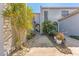 Charming home with stone pathway leading to arched entryway surrounded by lush, tropical landscaping at 6320 Grand Bahama Cir # 6320, Tampa, FL 33615