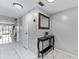 Bright hallway featuring tiled floor, entry table, and a mirror at 6320 Grand Bahama Cir # 6320, Tampa, FL 33615