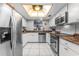 Kitchen with white cabinets, stainless steel appliances, tiled floor and a skylight at 6320 Grand Bahama Cir # 6320, Tampa, FL 33615