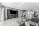 Open living room featuring tile floors, dark wood entertainment center, and access to patio at 6320 Grand Bahama Cir # 6320, Tampa, FL 33615