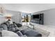 Cozy living room with a comfortable sectional sofa, entertainment center, and beautiful water views at 6320 Grand Bahama Cir # 6320, Tampa, FL 33615