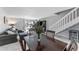 Open-concept living area with dining table and chairs, modern decor, and large windows overlooking the water at 6320 Grand Bahama Cir # 6320, Tampa, FL 33615