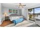 Bright main bedroom with balcony access, hardwood floors, ceiling fan and water view at 6320 Grand Bahama Cir # 6320, Tampa, FL 33615