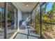 Relaxing screened porch with comfortable seating, beautiful garden, and natural light at 6320 Grand Bahama Cir # 6320, Tampa, FL 33615