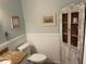 Charming bathroom featuring beadboard wainscoting, granite countertops, and rustic decor at 103 Old Mill Pond Rd, Palm Harbor, FL 34683