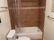 Bathroom featuring a white bathtub with shower head and tiled wall with mosaic accent at 103 Old Mill Pond Rd, Palm Harbor, FL 34683
