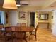 Bright dining room featuring wood floors, large windows, and seating for six; a delightful space for gatherings at 103 Old Mill Pond Rd, Palm Harbor, FL 34683