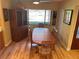 Bright dining room with wood floors, large window, wood table and chairs and built-in china cabinet at 103 Old Mill Pond Rd, Palm Harbor, FL 34683