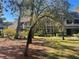 Beautifully landscaped exterior view of the home showcasing its curb appeal and natural surroundings at 103 Old Mill Pond Rd, Palm Harbor, FL 34683