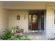 Charming front entrance with decorative planters, a warm wood door, and flagstone steps at 103 Old Mill Pond Rd, Palm Harbor, FL 34683