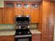 This updated kitchen features granite counters, stainless steel appliances and wood cabinets with a complementary backsplash at 103 Old Mill Pond Rd, Palm Harbor, FL 34683