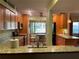 Updated eat-in kitchen showcasing wood cabinets, granite counters, stainless appliances, corner dinette and tiled floor at 103 Old Mill Pond Rd, Palm Harbor, FL 34683