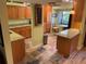 Warm kitchen features granite counters, wood cabinets, a corner dinette and tile floors with stainless steel appliances at 103 Old Mill Pond Rd, Palm Harbor, FL 34683